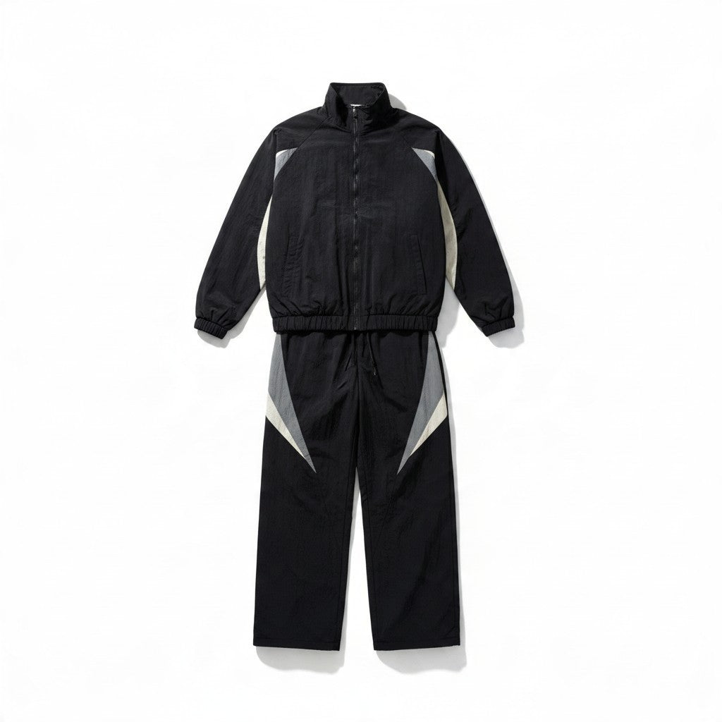 Ensemble survêtement rétro bonhomme en nylon noir avec empiècements gris et écru, doublé polaire, coupe ample 90's